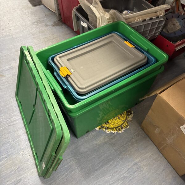Assorted plastic storage containers stacked together for household organisation.