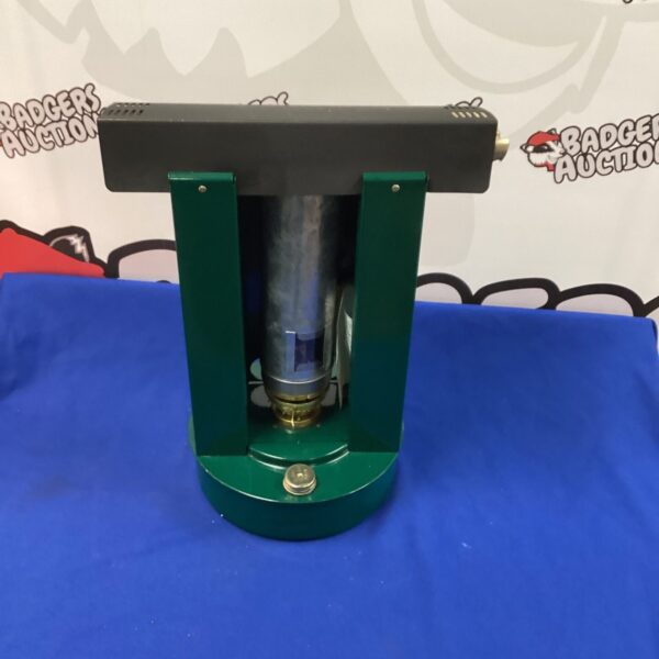 Vintage green paraffin heater with glass reservoir.