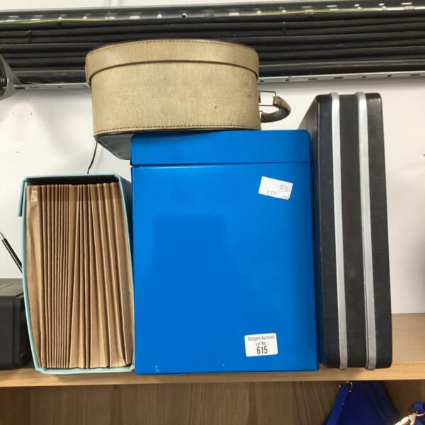 Lot of four vintage suitcases in varying sizes.