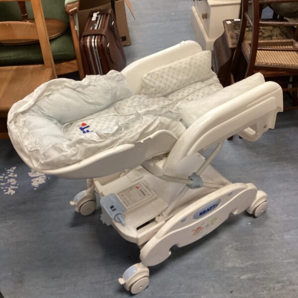 Vintage Kraft electric rocking bed for infants in a nursery setting.