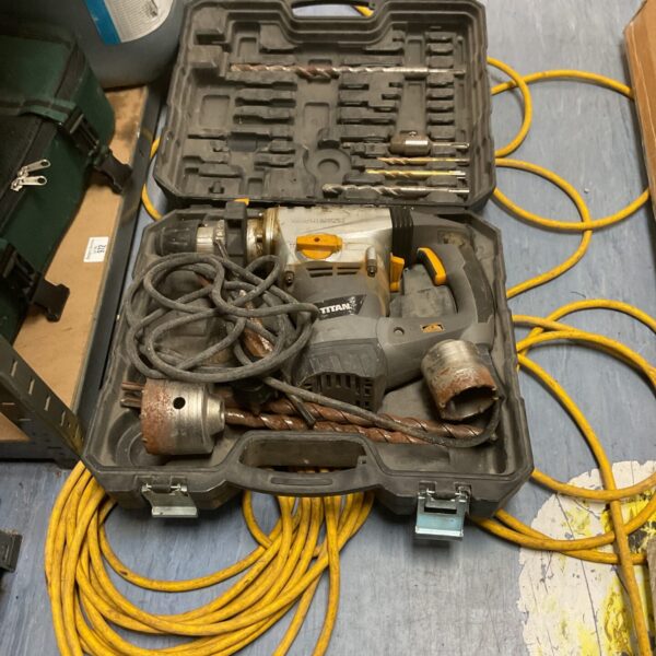Titan 240v rotary hammer drill in a black carrying case.
