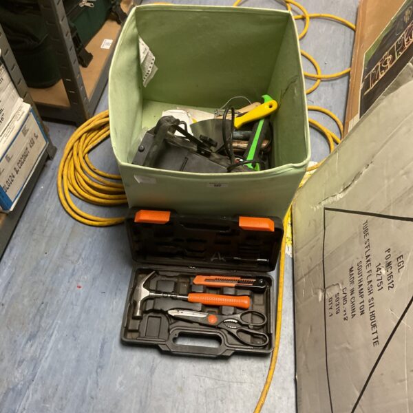 Mixed tool lot with scraper, hammer, and work light.