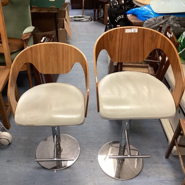 Pair of vintage Danish style swivel stools with beige seats.