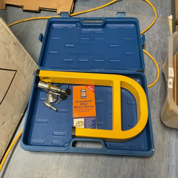 Stronghold wheel clamp inside a plastic carrying case.