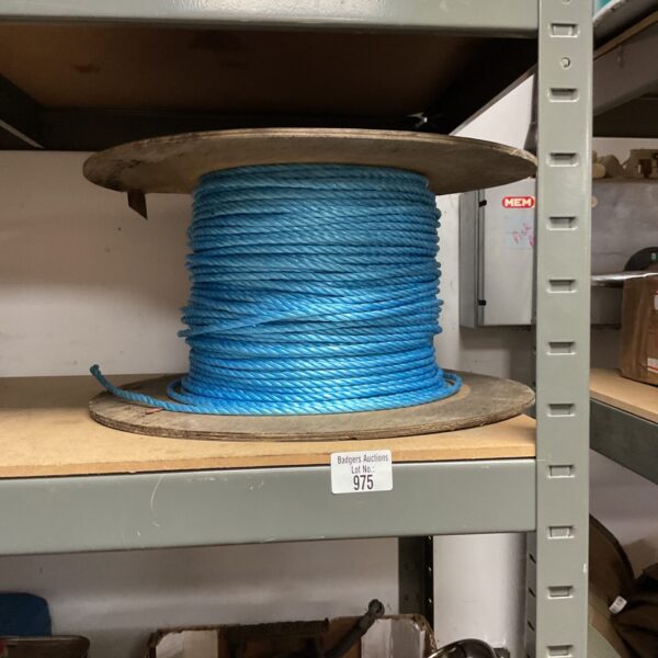 Blue nylon rope coil on a plastic reel for industrial use.