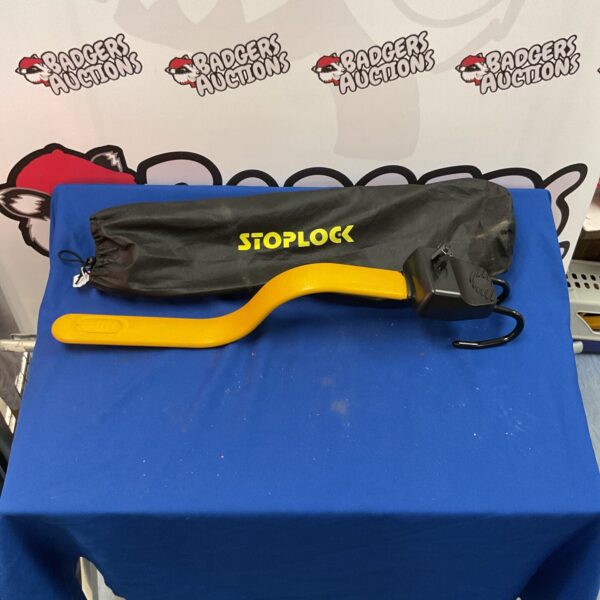 Yellow Stoplock steering wheel lock for car security.