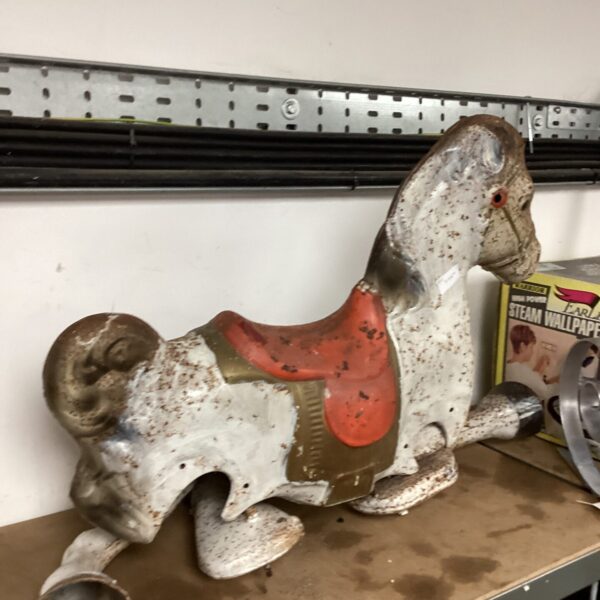 Antique metal child's horse needing restoration, vintage toy.