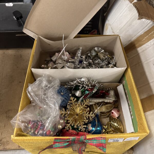 Vintage Christmas ornaments in a cardboard box, colourful and collectible.