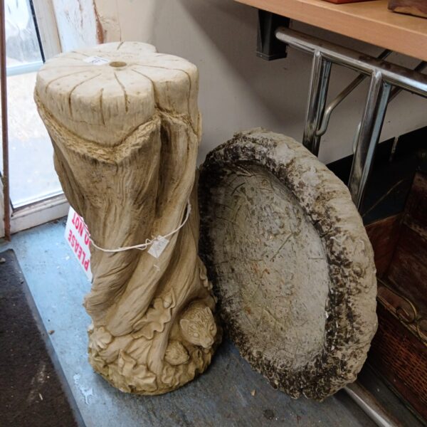 Vintage concrete tree trunk bird bath for garden use.