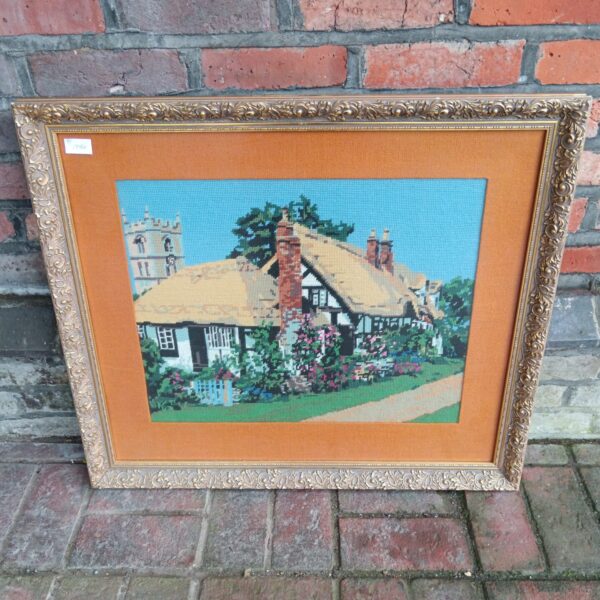 Large vintage thatched cottage tapestry with a gilt frame.