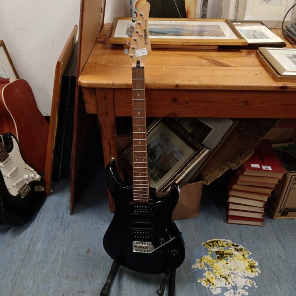 Black Yamaha Erg 121 electric guitar, vintage 1980s instrument.