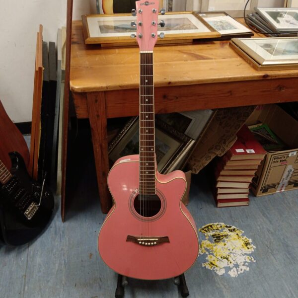 Vibrant pink acoustic guitar on display, musical instrument.
