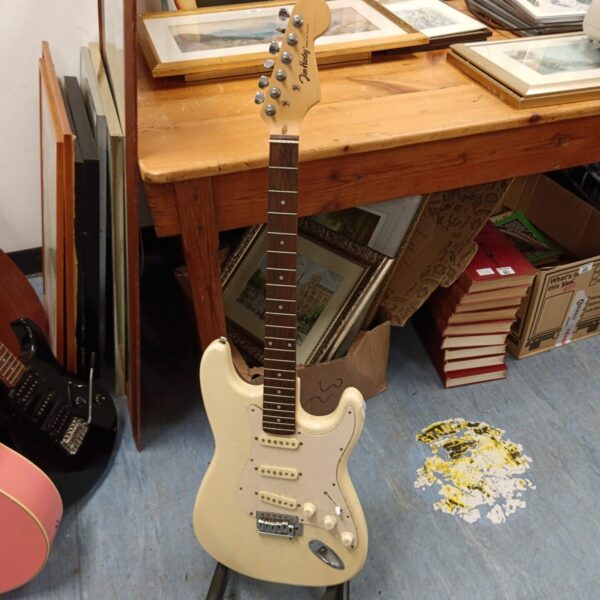 White Jim Harley electric guitar needing restoration.