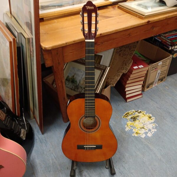 Vintage Valencia VC103K acoustic guitar in a home setting.