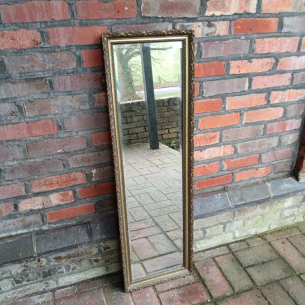 Ornate vintage bevelled edge mirror with gilded frame.