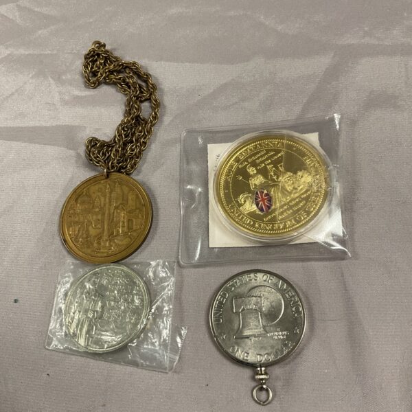 Vintage London medallion collection with coins and medallions.