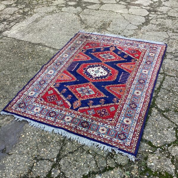 Colourful Aztec patterned rug with geometric design.