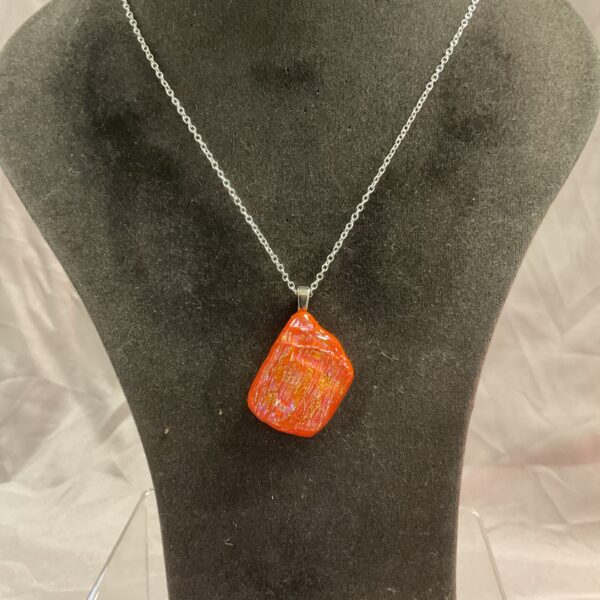 Vibrant glass pendant necklace on a silver chain.