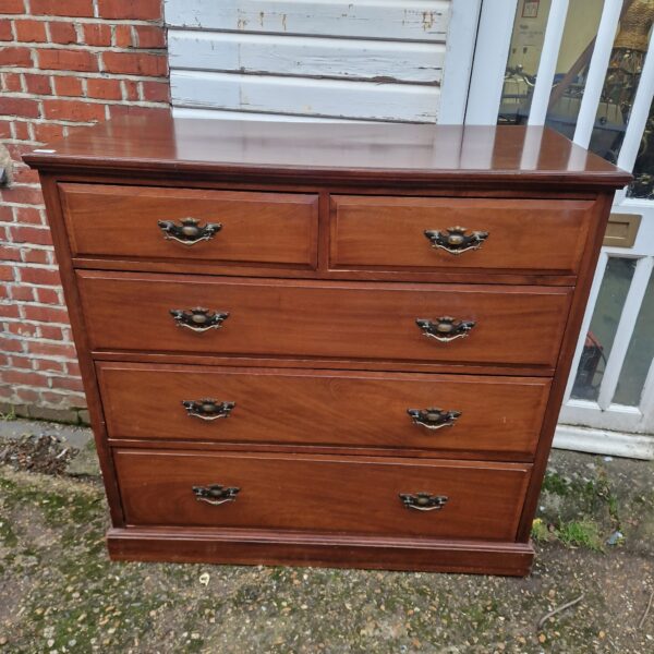 Antique mahogany chest of drawers with four drawers, vintage bedroom storage.