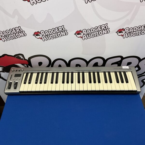 Vintage Acorn Masterkey 49 MIDI keyboard for music production.