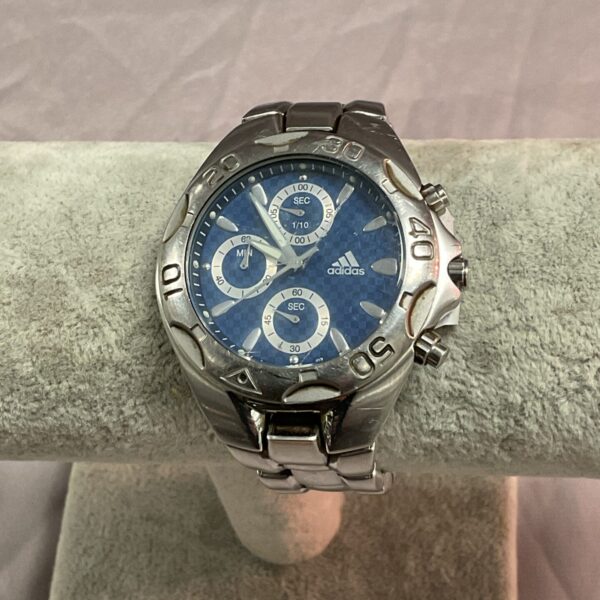 Adidas gents quartz wristwatch with a blue dial and stainless steel bracelet.