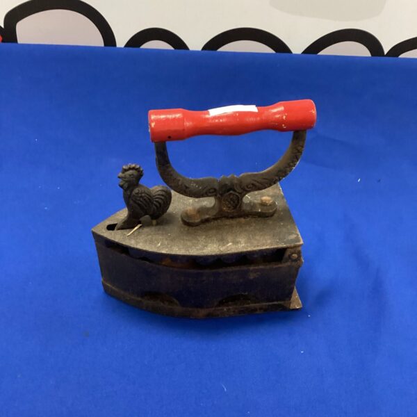 Antique cast iron smoothing iron with wooden handle.