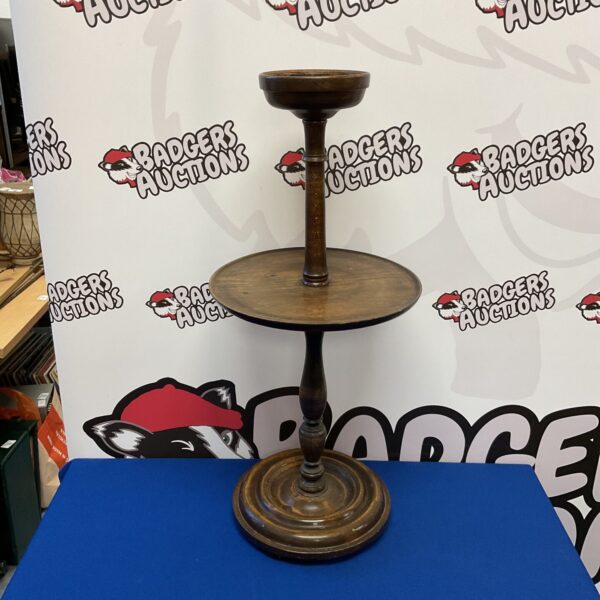 Antique mahogany two-tier table with turned pedestal base.