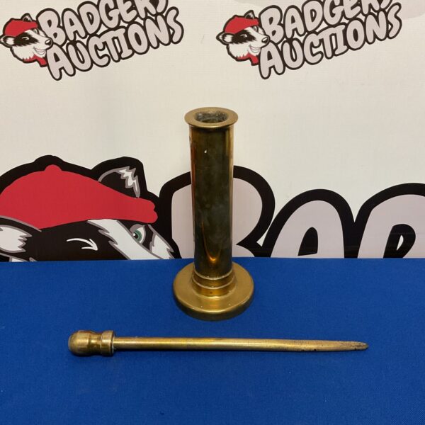 Antique brass fireplace poker with a rounded handle.