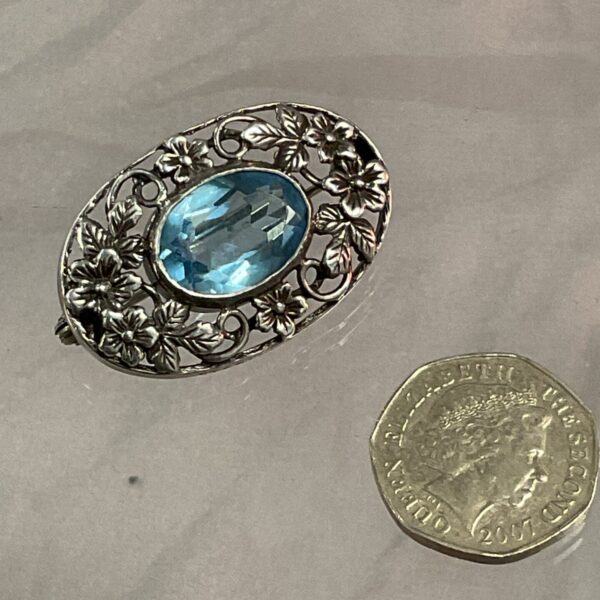 Antique sterling silver Art Nouveau brooch with blue stone.