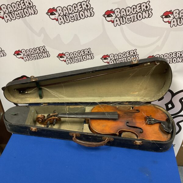 Antique violin in open case with bow, vintage stringed instrument.