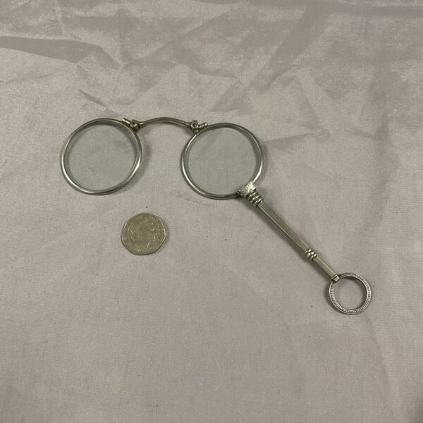 Antique white metal lorgnettes, a Victorian folding spectacle.