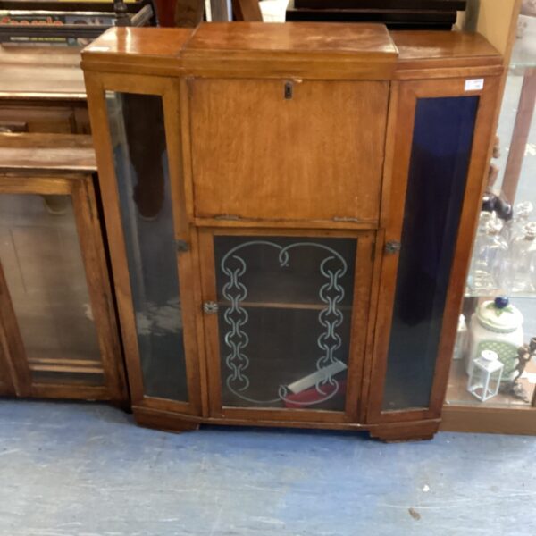 Vintage Art Deco oak display cabinet with curved glass front.