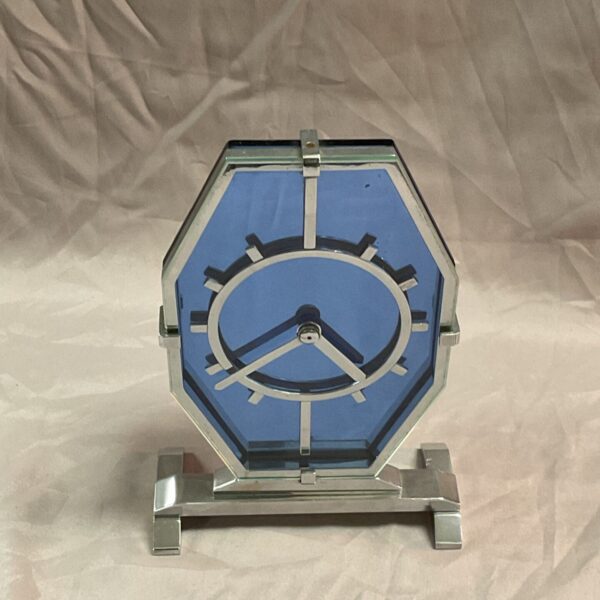 Vintage Art Deco electric clock with blue face and chrome frame.