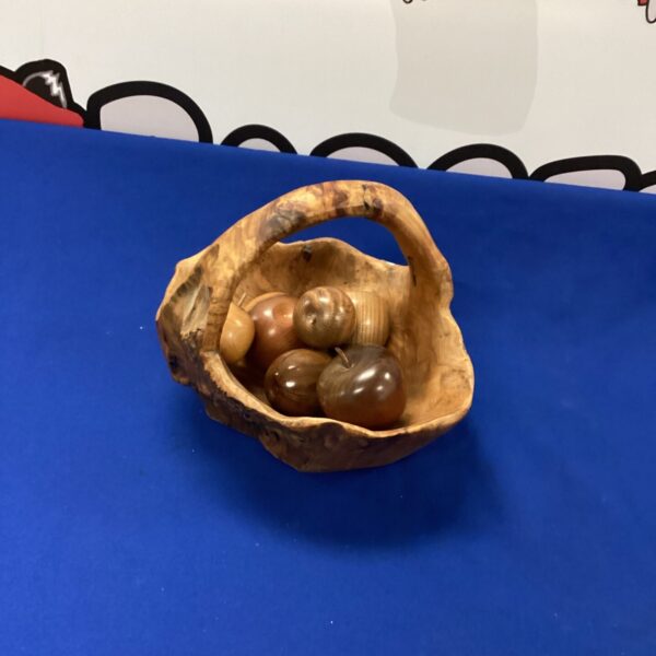 Hand-carved wooden fruit basket, rustic decorative sculpture.