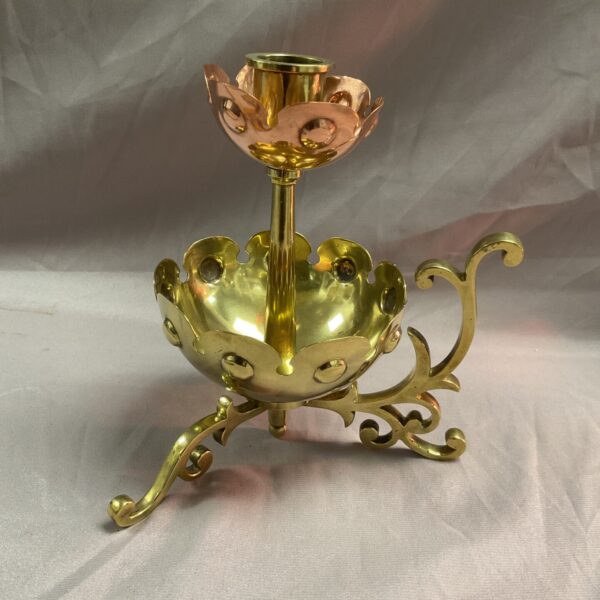 Antique Arts and Crafts chamberstick with petal details.