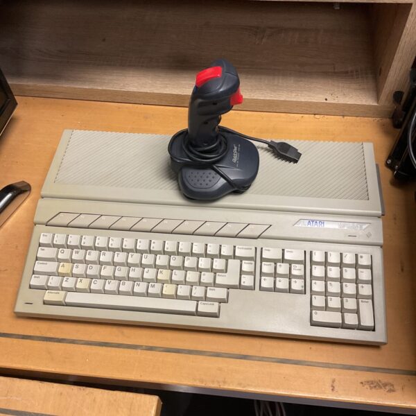 Vintage Atari 1040ST computer with joystick for retro gaming.