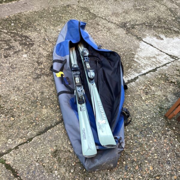 Atomic Cardon ski set with poles and case for winter sports.