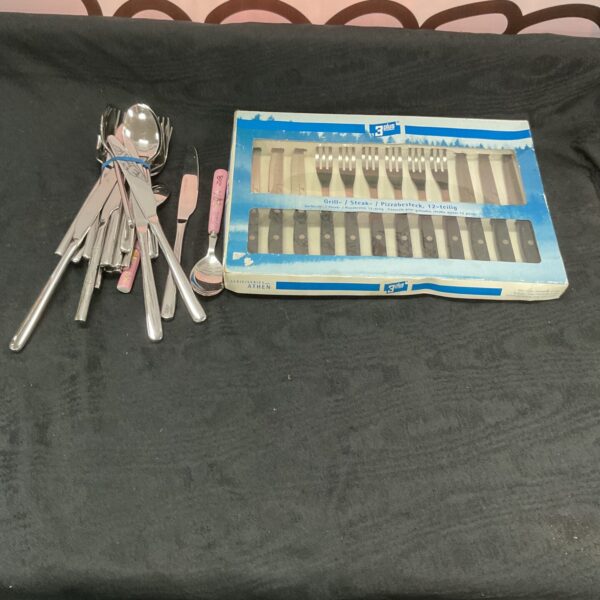 Vintage Athen cutlery set with mixed stainless steel pieces.