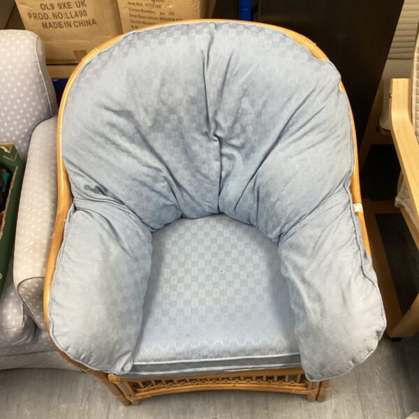 Vintage bamboo conservatory chair with patterned seat.