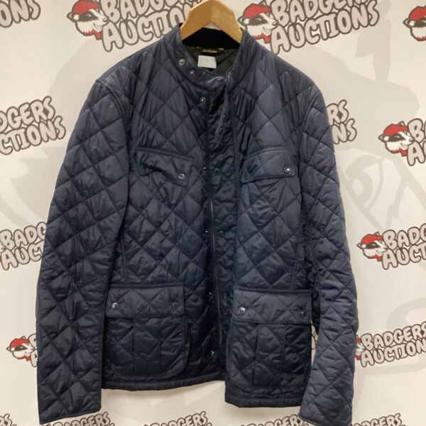 Front view of a navy Barbour quilted jacket.