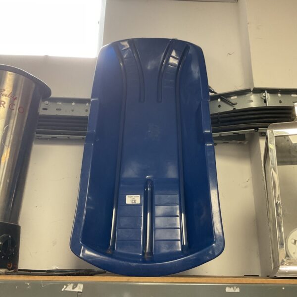Blue plastic sledge for winter snow fun, a classic outdoor toy.