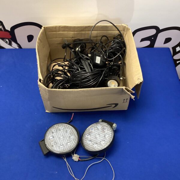 Collection of LED garden spot lights in a cardboard box.
