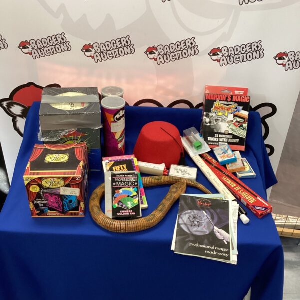 Vintage magic trick collection with boxes and props.