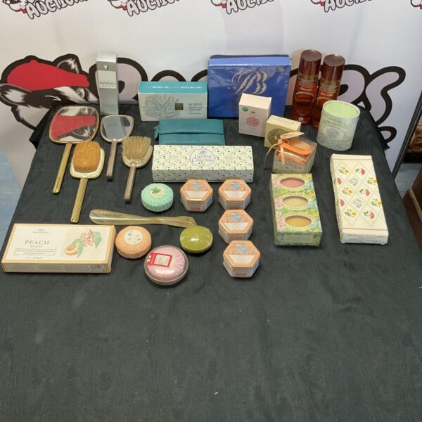 Vintage dressing table set with brushes, mirrors, and cosmetic items.