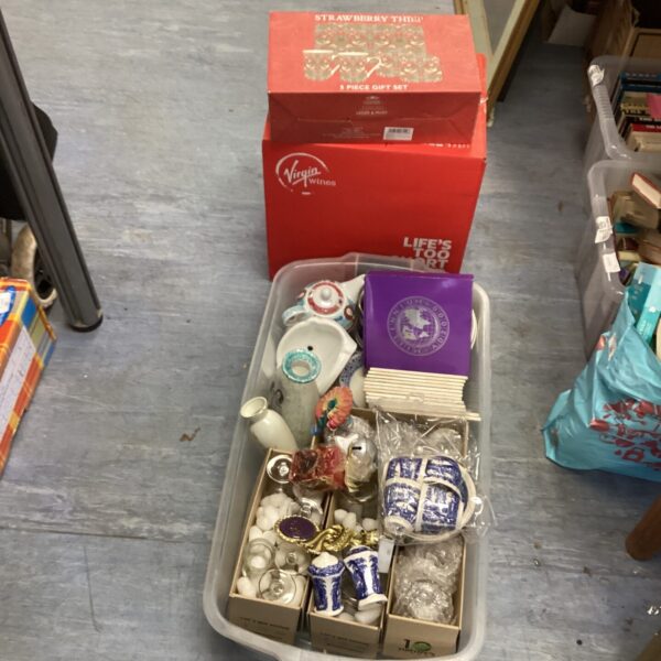 Mixed lot of vintage china and glassware on display.
