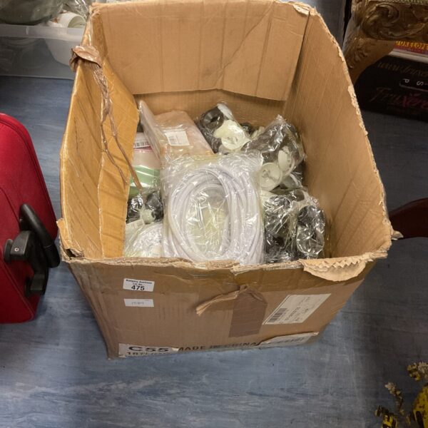 Box of mixed new products and retail stock.