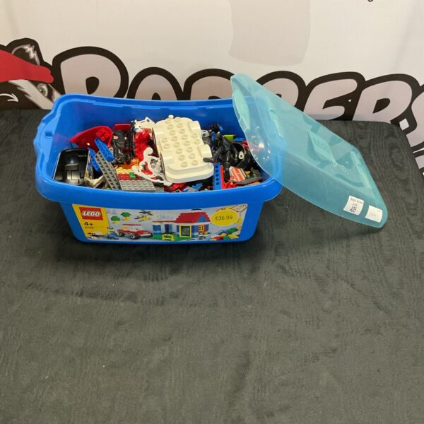 Assorted mixed Lego building blocks in a plastic storage box.