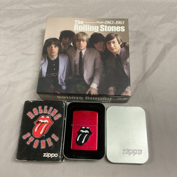 Vintage Rolling Stones Zippo lighter with boxed CD set.