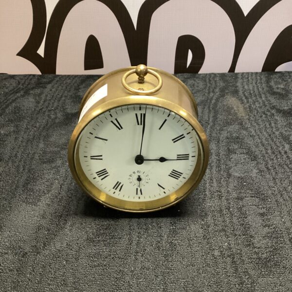 Antique brass carriage clock with Swiss movement and hinged handle.