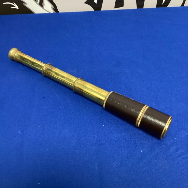 Antique brass telescope with aged patina, vintage nautical decor.
